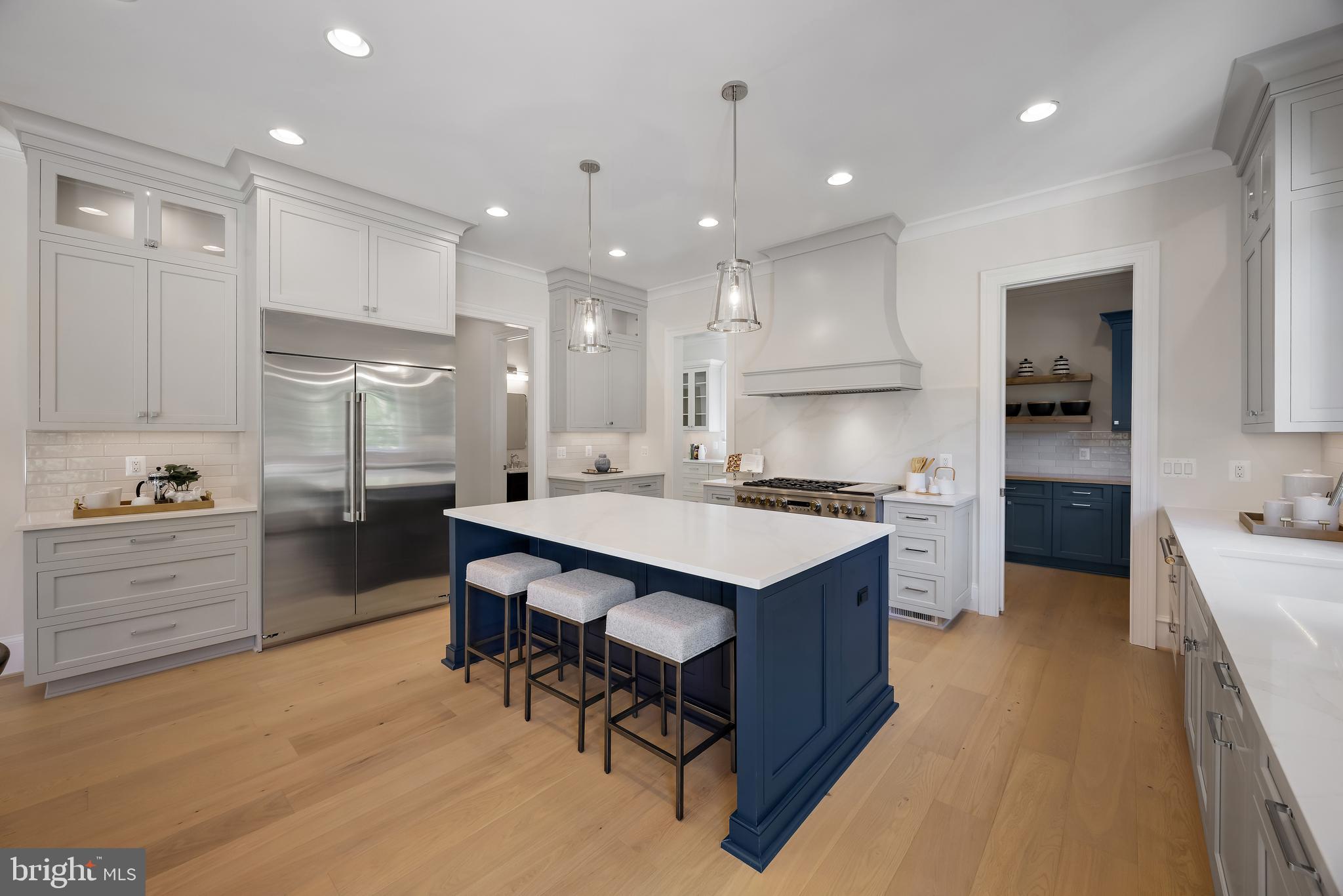 8628 Plymouth Road Alexandria, VA 22308 - Photo 16 of 50 a large kitchen with kitchen island a sink a stove a center island and a stove