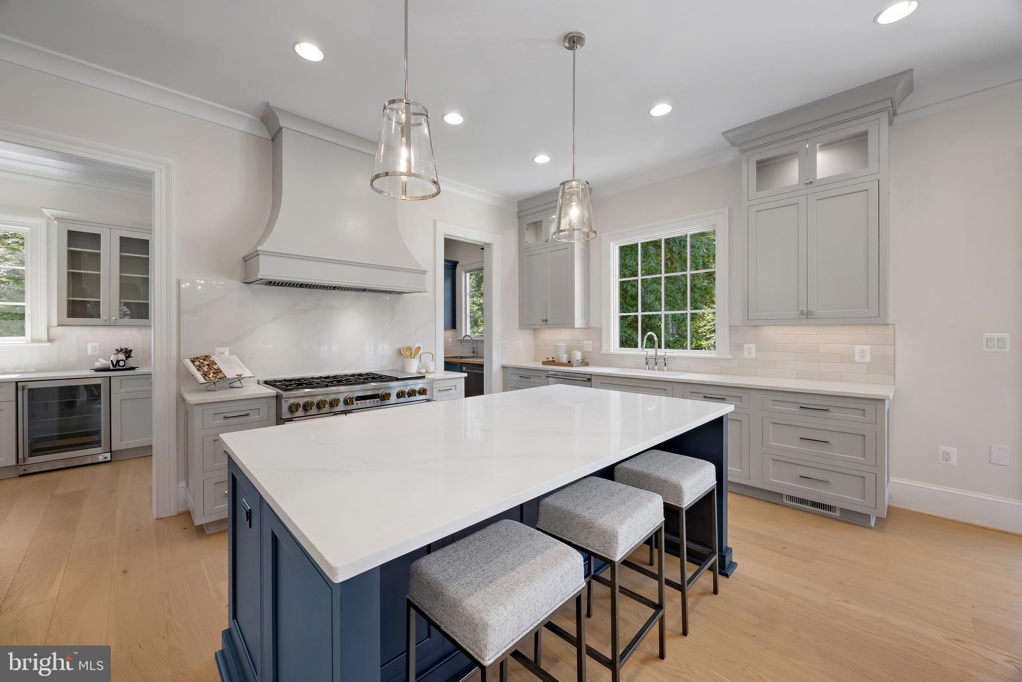 8628 Plymouth Road Alexandria, VA 22308 - Photo 17 of 50 a kitchen with a table chairs stove and microwave