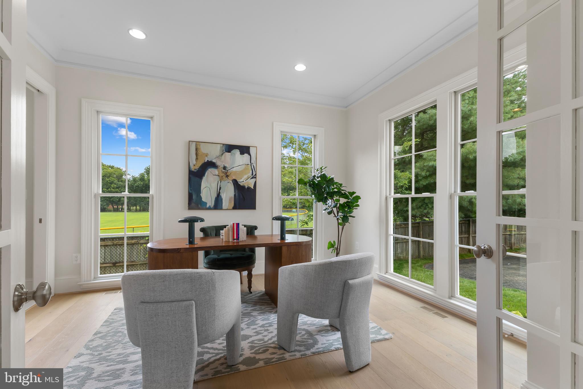 8628 Plymouth Road Alexandria, VA 22308 - Photo 23 of 50 a living room with furniture a lamp and a large window