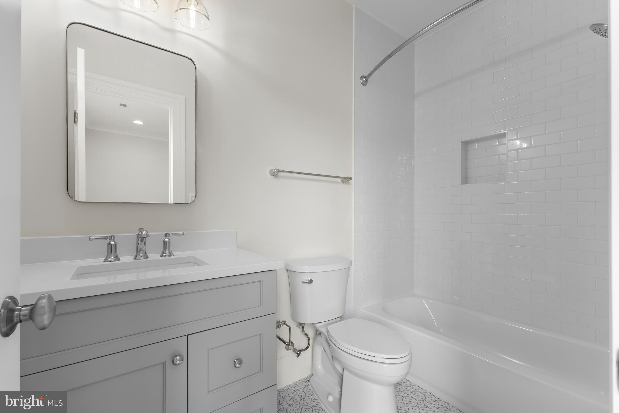 8628 Plymouth Road Alexandria, VA 22308 - Photo 34 of 50 a bathroom with a sink a toilet and a mirror