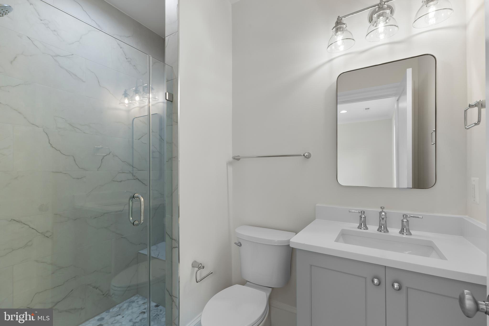 8628 Plymouth Road Alexandria, VA 22308 - Photo 37 of 50 a bathroom with a toilet sink vanity and granite