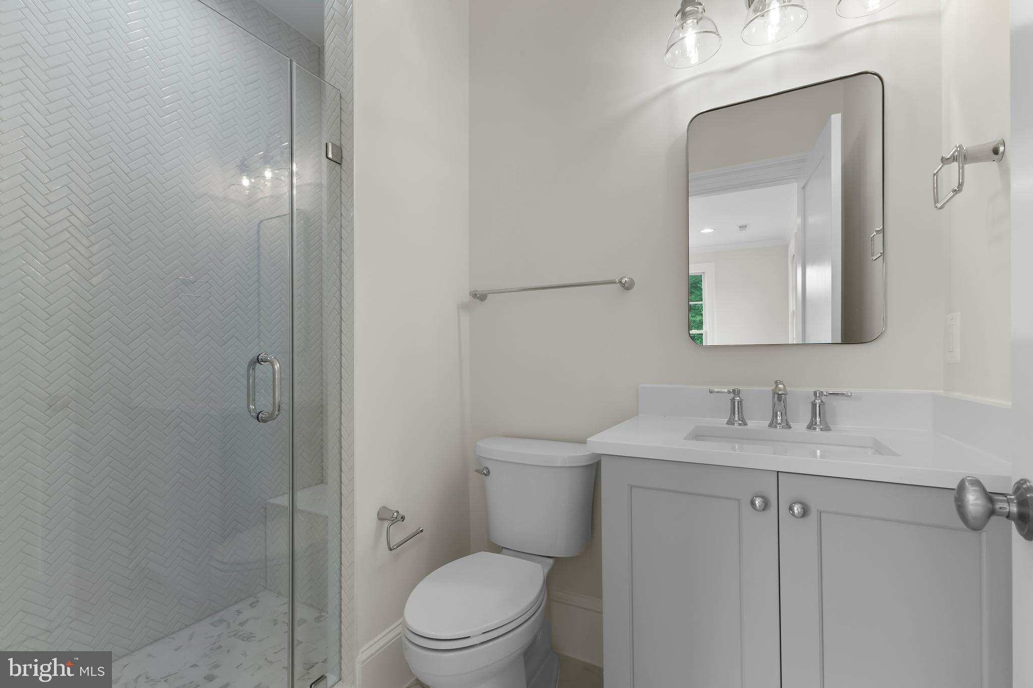 8628 Plymouth Road Alexandria, VA 22308 - Photo 39 of 50 a bathroom with a toilet a sink and mirror