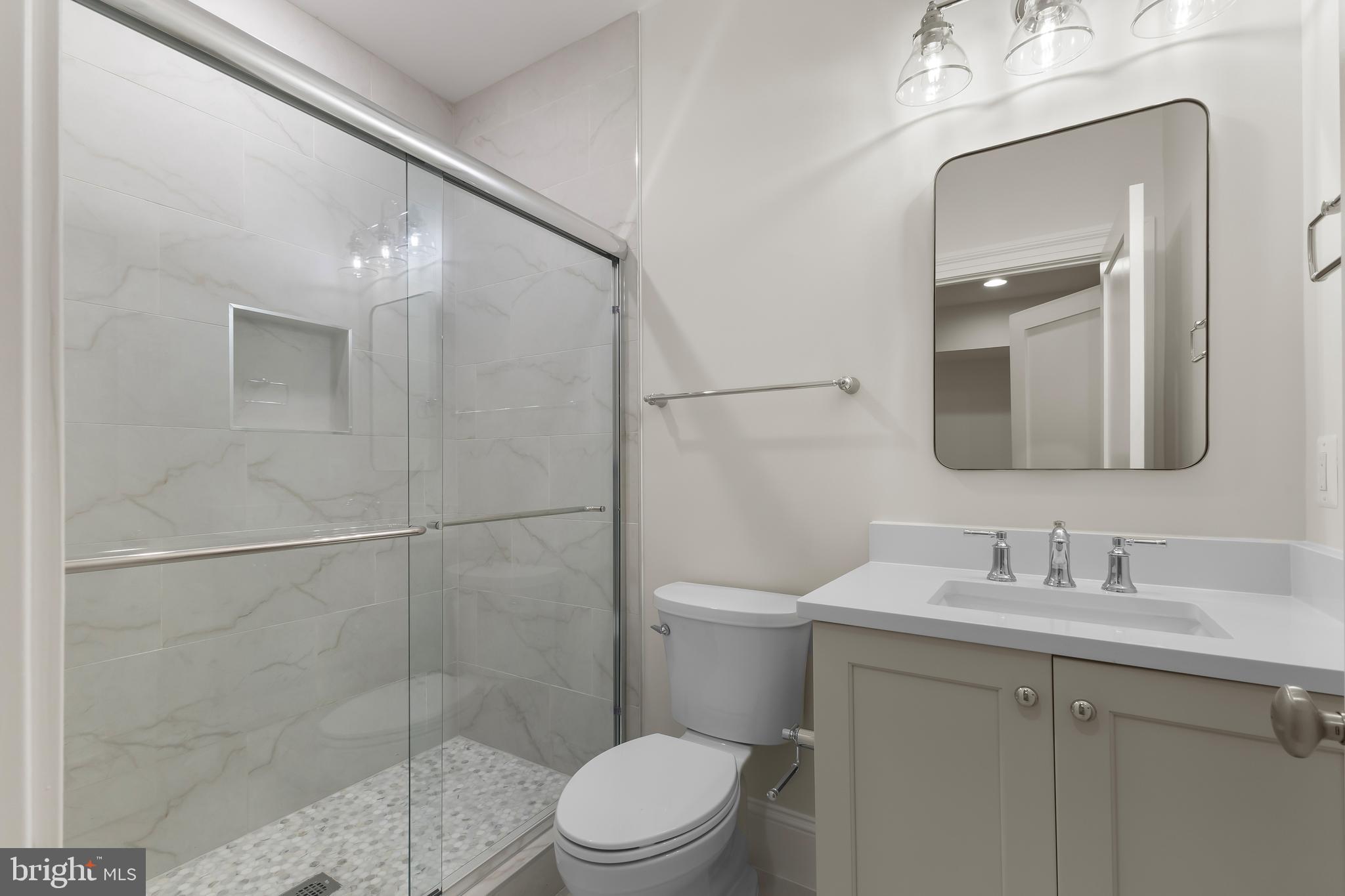 8628 Plymouth Road Alexandria, VA 22308 - Photo 49 of 50 a bathroom with a toilet a sink and shower