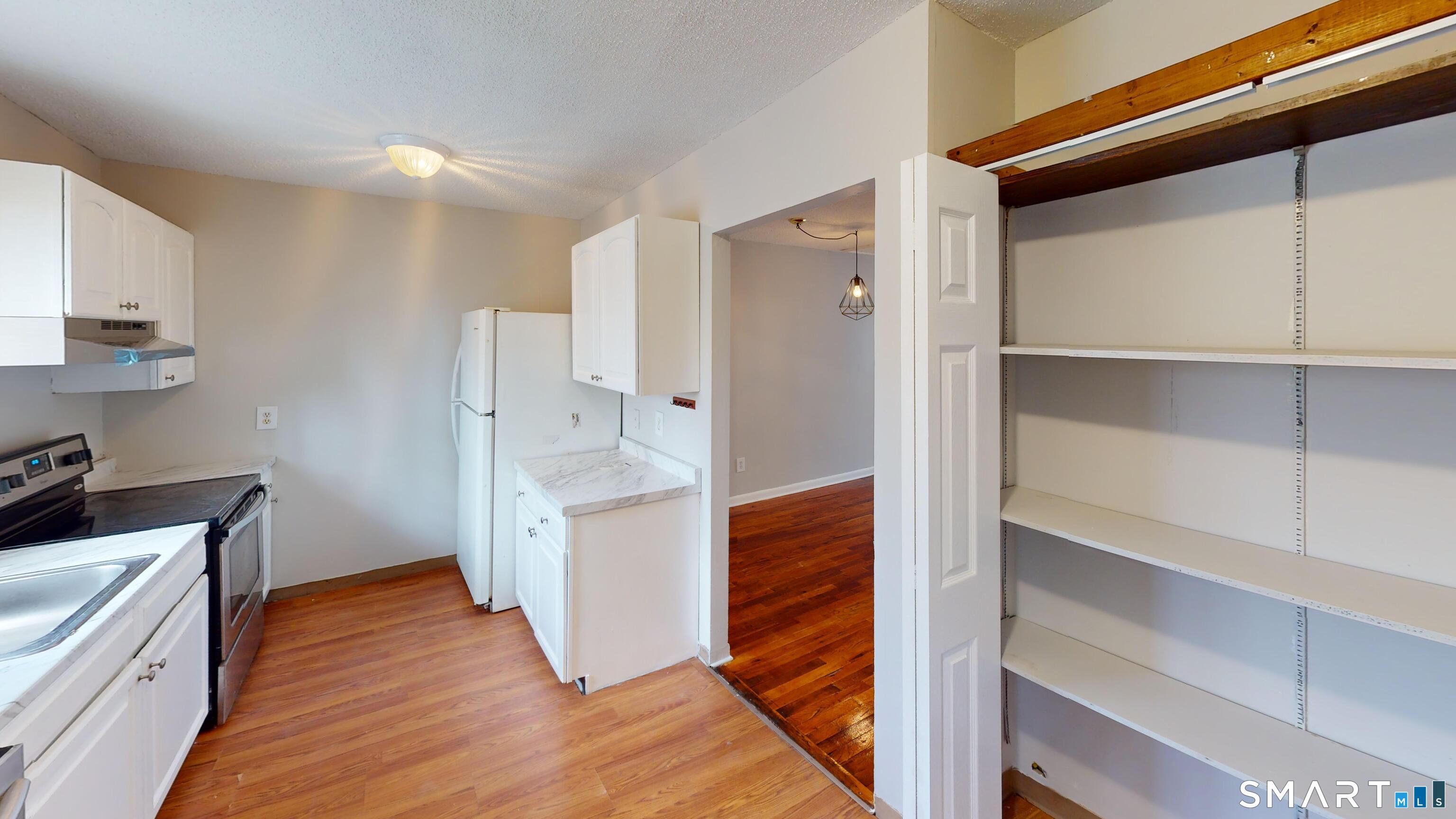 158 High Path Road, Unit 158 Windsor, CT 06095 - Photo 4 of 20 a view of kitchen with wooden floor and electronic appliances