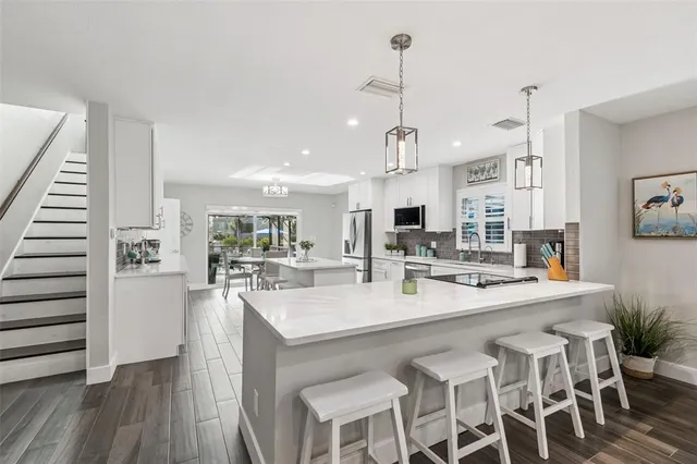 a view of a dining room with furniture large window and wooden floor
