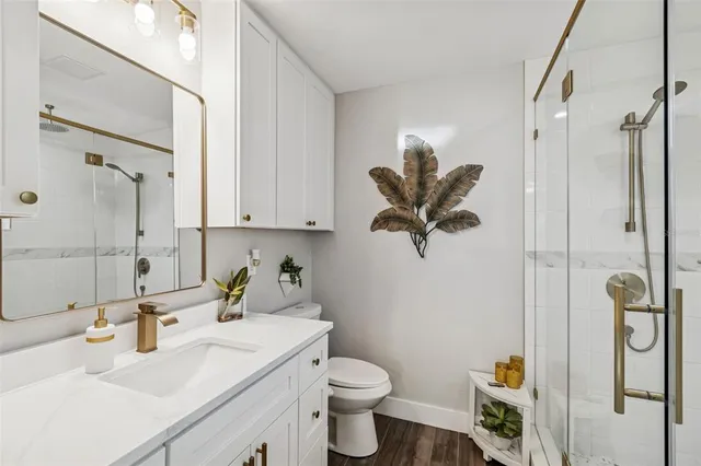 a white toilet sitting next to a bathroom sink