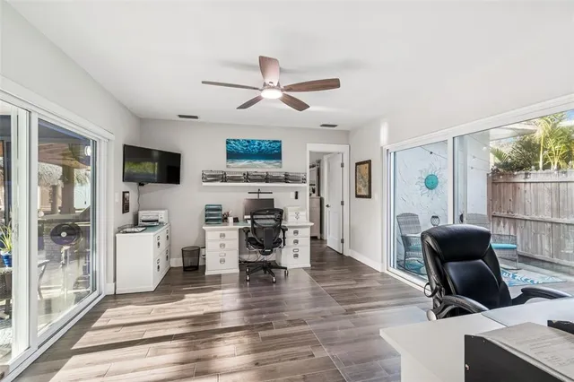 a spacious bedroom with a bed and a flat screen tv