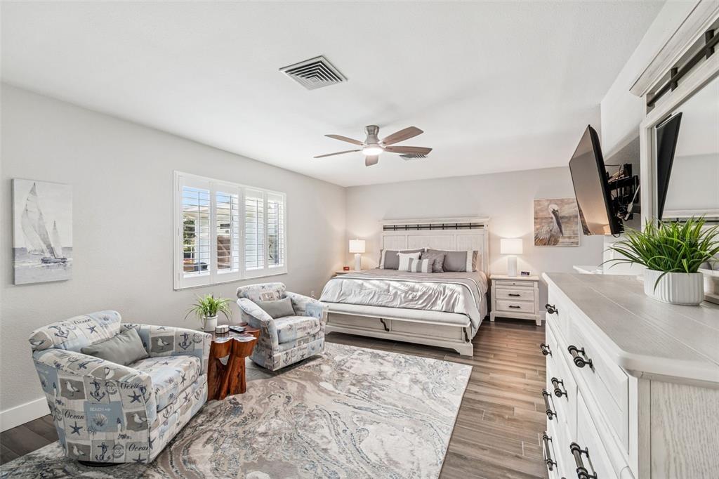 5809 Rio Drive New Port Richey, FL 34652 - Photo 25 of 61 a spacious bedroom with bed and a couch