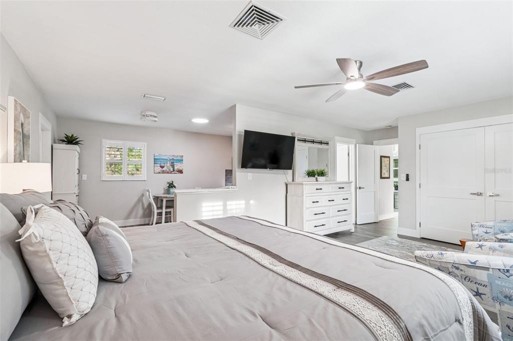 5809 Rio Drive New Port Richey, FL 34652 - Photo 26 of 61 a spacious bedroom with a bed and a flat screen tv