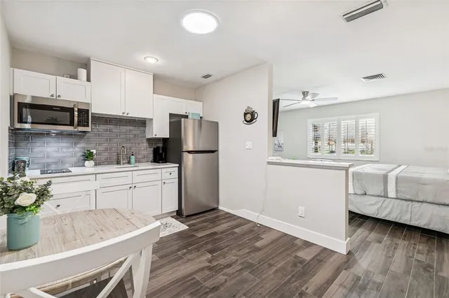 a spacious bedroom with a bed and a table in it