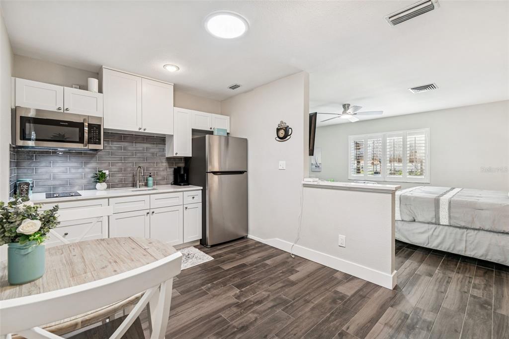 5809 Rio Drive New Port Richey, FL 34652 - Photo 27 of 61 a kitchen with white cabinets and stainless steel appliances