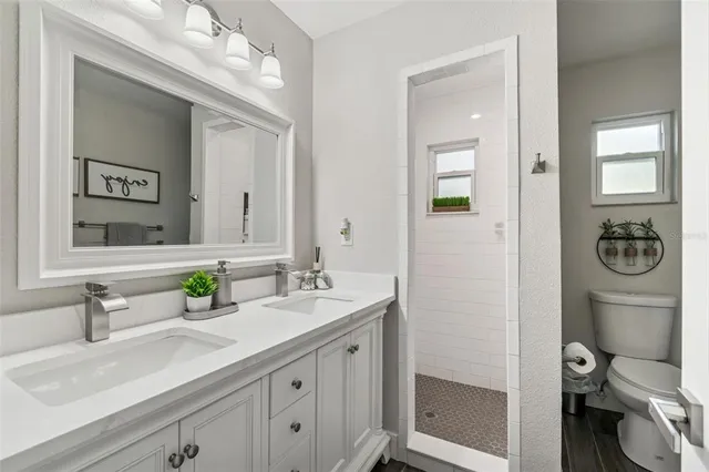 a view of washer and dryer with wooden cabinets