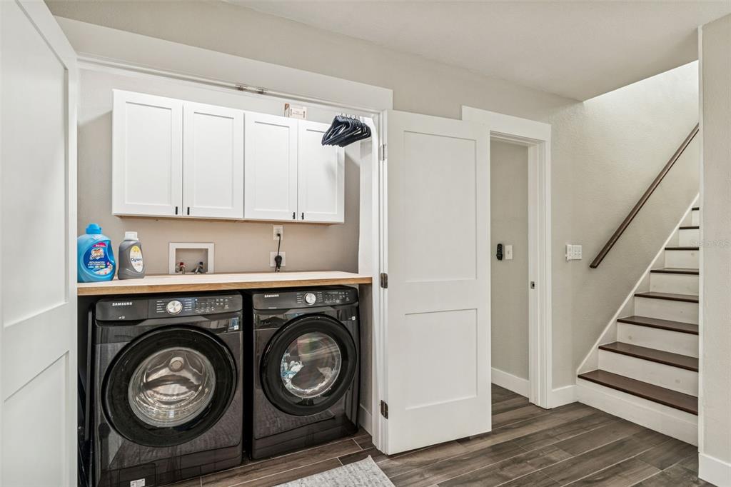 5809 Rio Drive New Port Richey, FL 34652 - Photo 34 of 61 a view of washer and dryer with wooden cabinets