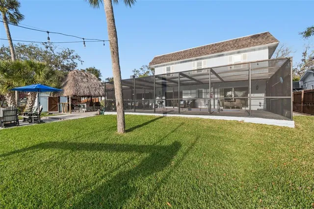 a view of a chairs and table in the patio with a yard