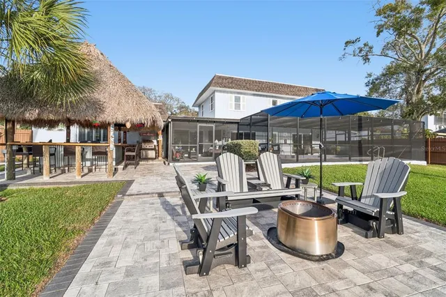a view of swimming pool with seating area and furniture