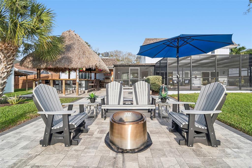 5809 Rio Drive New Port Richey, FL 34652 - Photo 43 of 61 a view of a table and chairs under an umbrella