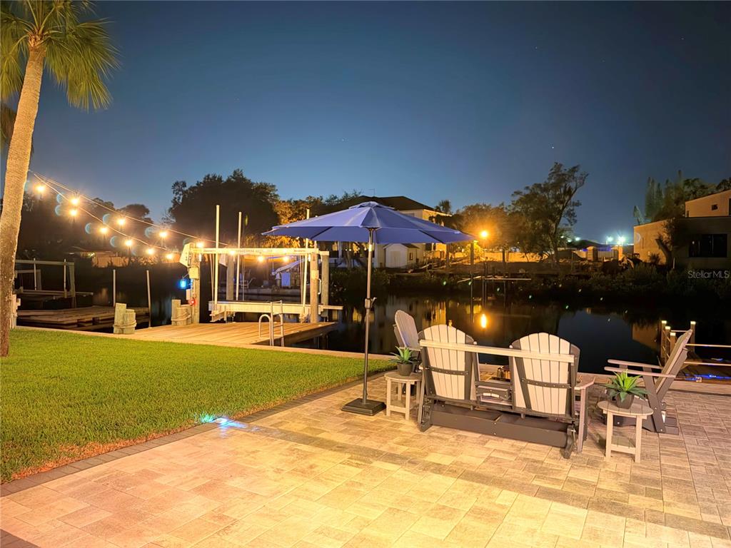 5809 Rio Drive New Port Richey, FL 34652 - Photo 7 of 61 a view of a patio with a table and chairs under an umbrella