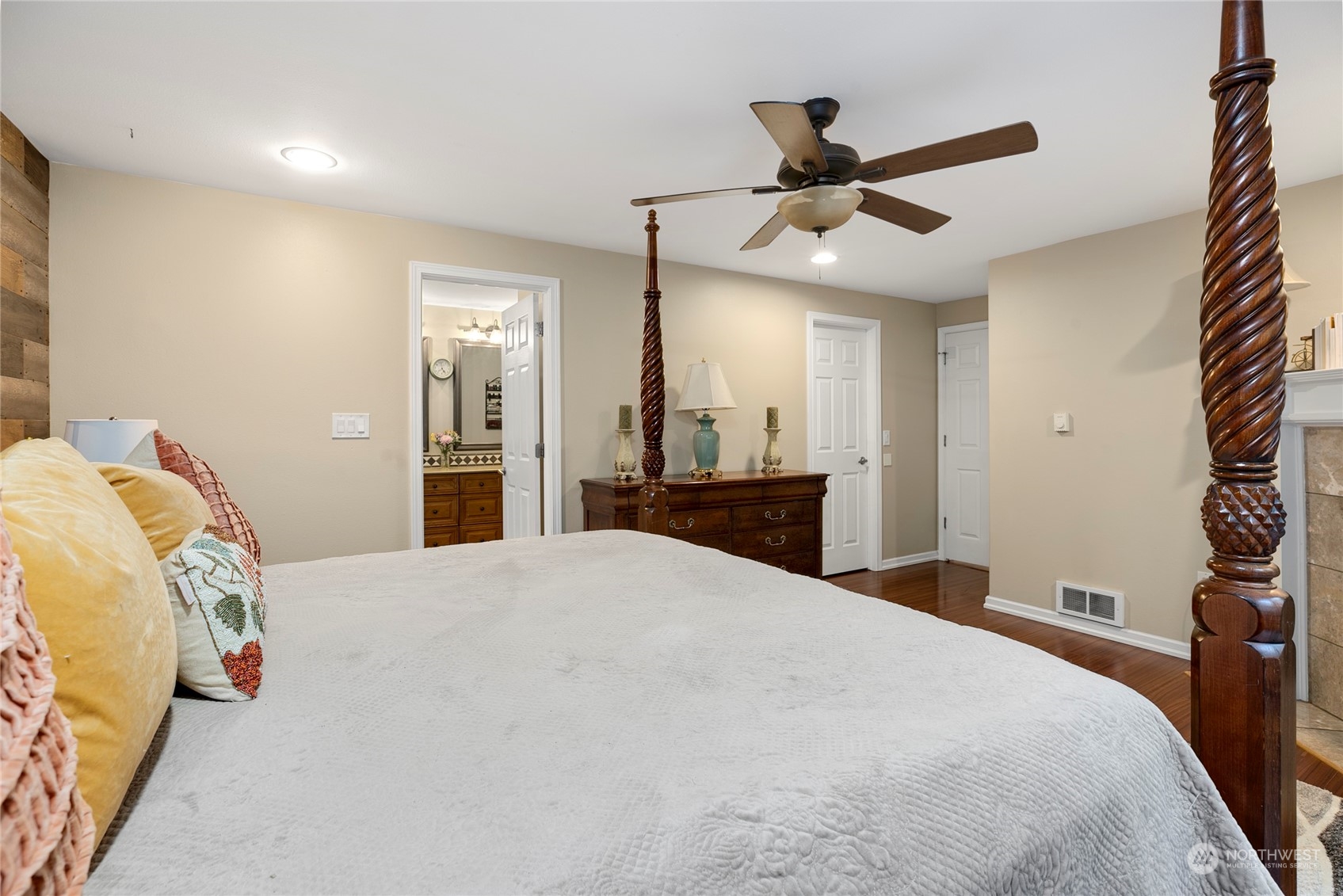 1124 Summit Lake Shore Road Northwest Olympia, WA 98502 - Photo 16 of 40 a bedroom with a bed and a chandelier