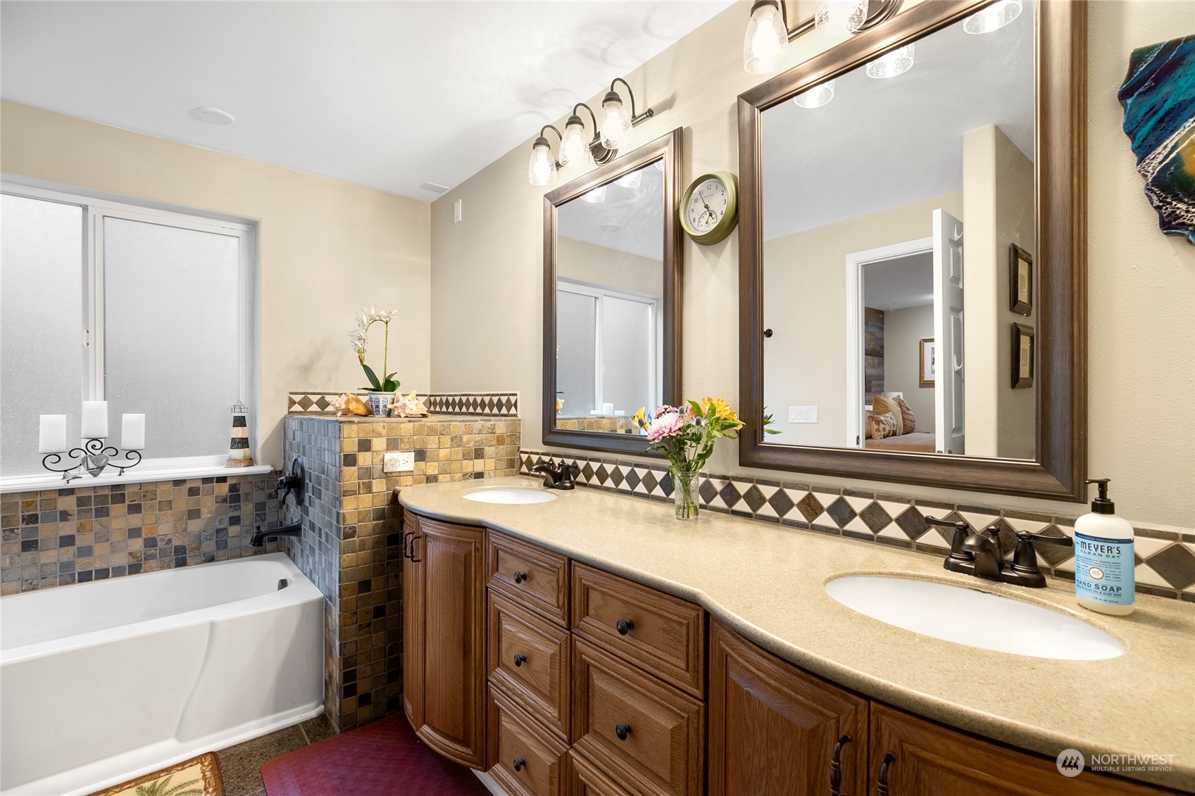 1124 Summit Lake Shore Road Northwest Olympia, WA 98502 - Photo 17 of 40 a bathroom with a tub sink and mirror