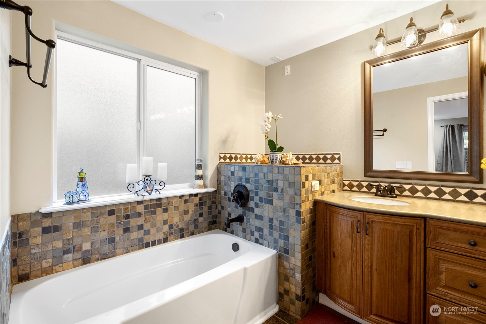 1124 Summit Lake Shore Road Northwest Olympia, WA 98502 - Photo 19 of 40 a bathroom with a tub sink and mirror