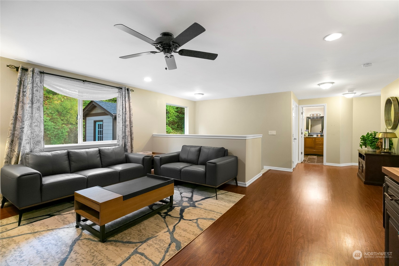 1124 Summit Lake Shore Road Northwest Olympia, WA 98502 - Photo 20 of 40 a living room with furniture and a large window
