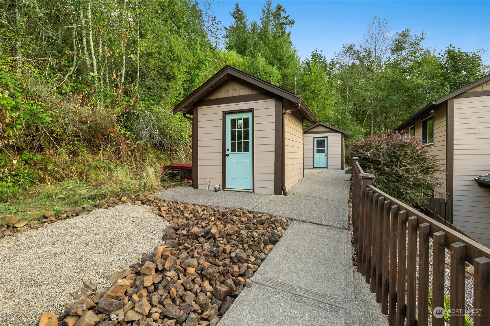 1124 Summit Lake Shore Road Northwest Olympia, WA 98502 - Photo 38 of 40 a view of a house with a small yard and wooden fence