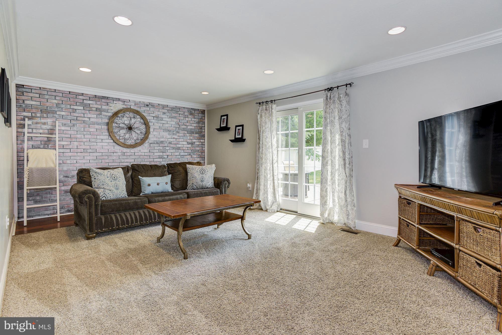 6 Mariner Drive Sewell, NJ 08080 - Photo 11 of 32 a living room with furniture a flat screen tv and a window