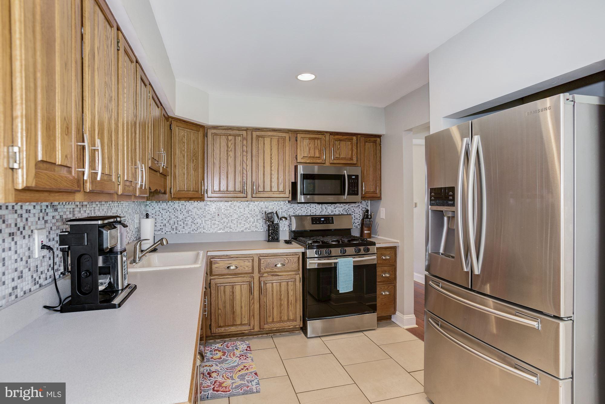 6 Mariner Drive Sewell, NJ 08080 - Photo 14 of 32 a kitchen with stainless steel appliances granite countertop a refrigerator sink and stove