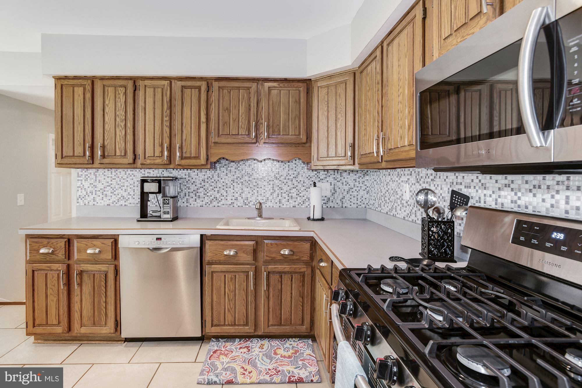 6 Mariner Drive Sewell, NJ 08080 - Photo 15 of 32 a kitchen with a stove a sink and a cabinets
