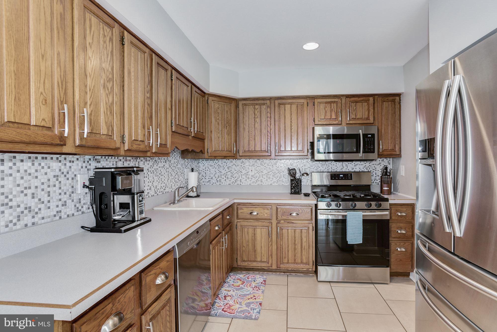 6 Mariner Drive Sewell, NJ 08080 - Photo 16 of 32 a kitchen with a sink a stove top oven and refrigerator