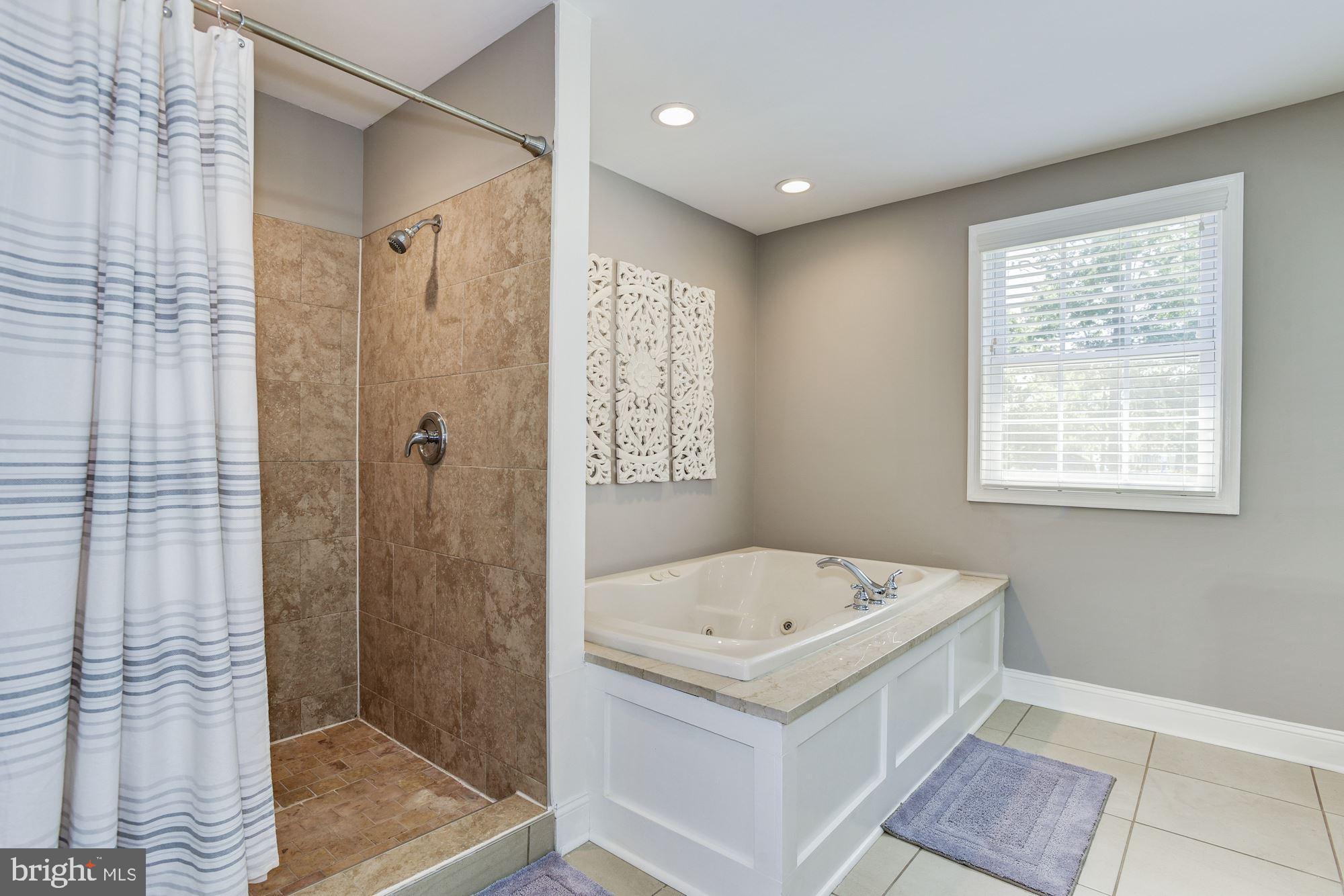 6 Mariner Drive Sewell, NJ 08080 - Photo 23 of 32 a bathroom with a bath tub a shower and a sink