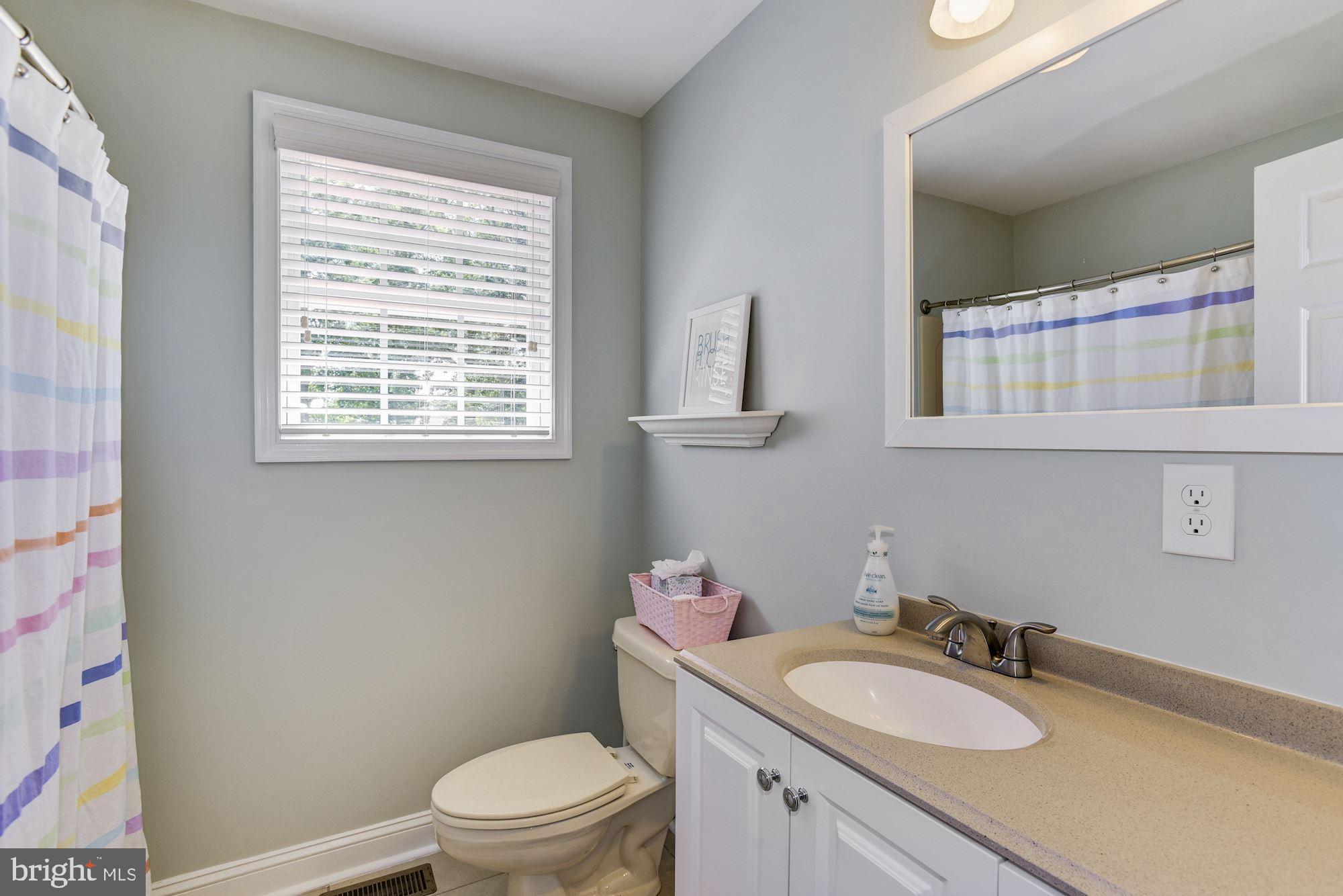 6 Mariner Drive Sewell, NJ 08080 - Photo 27 of 32 a bathroom with a granite countertop toilet a sink a mirror and a window