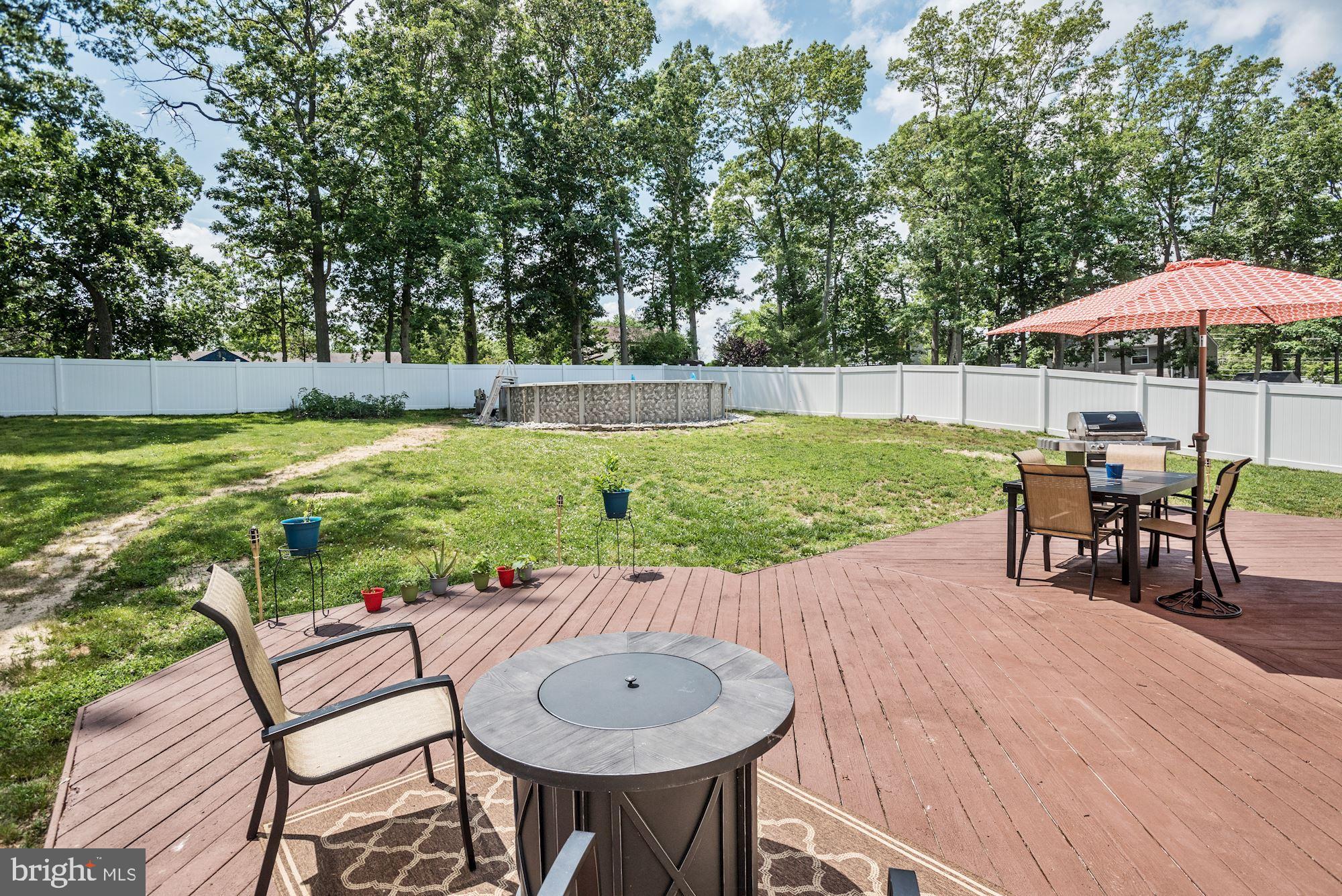 6 Mariner Drive Sewell, NJ 08080 - Photo 31 of 32 a view of a patio with a table and chairs under an umbrella