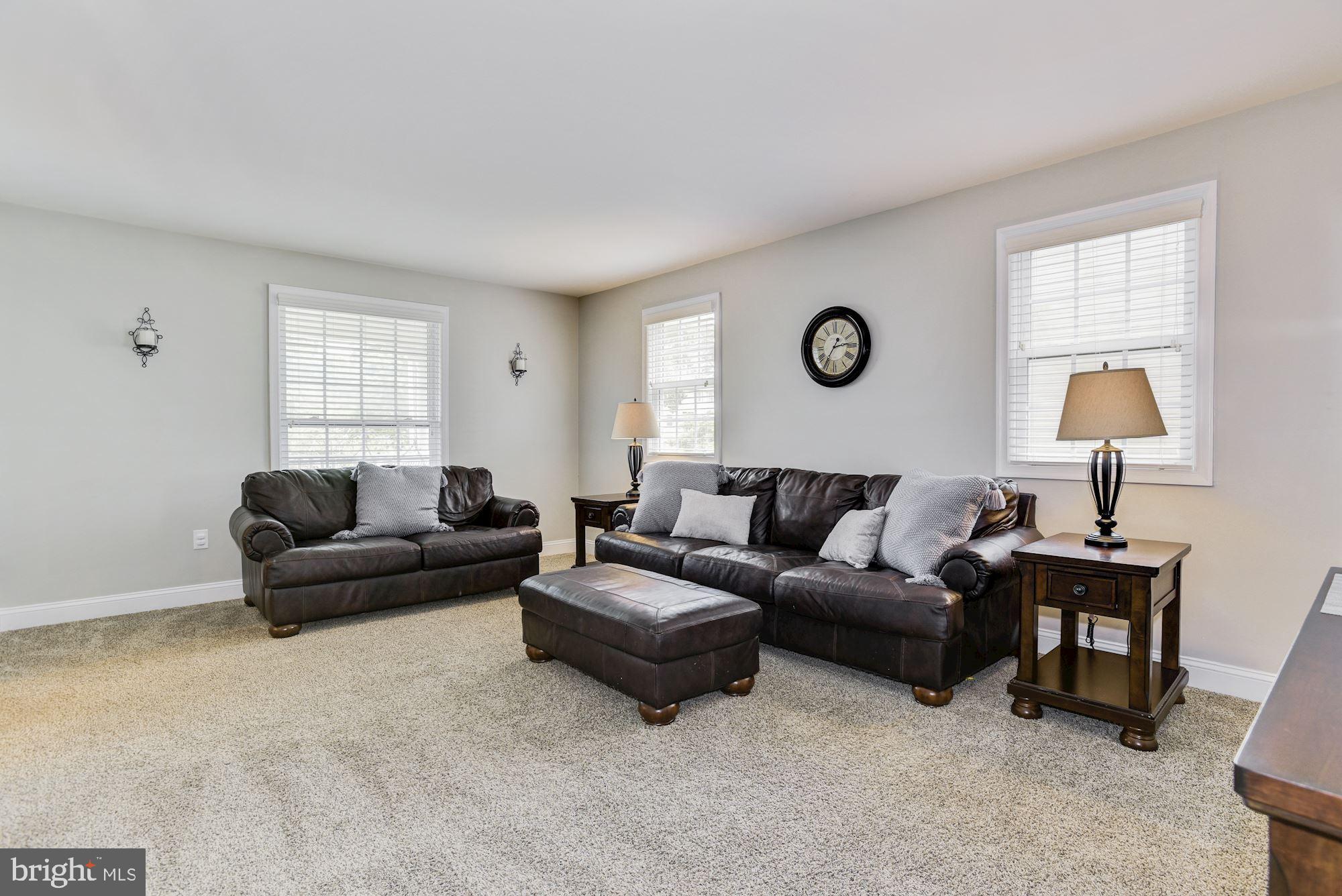 6 Mariner Drive Sewell, NJ 08080 - Photo 8 of 32 a living room with furniture a lamp and a window