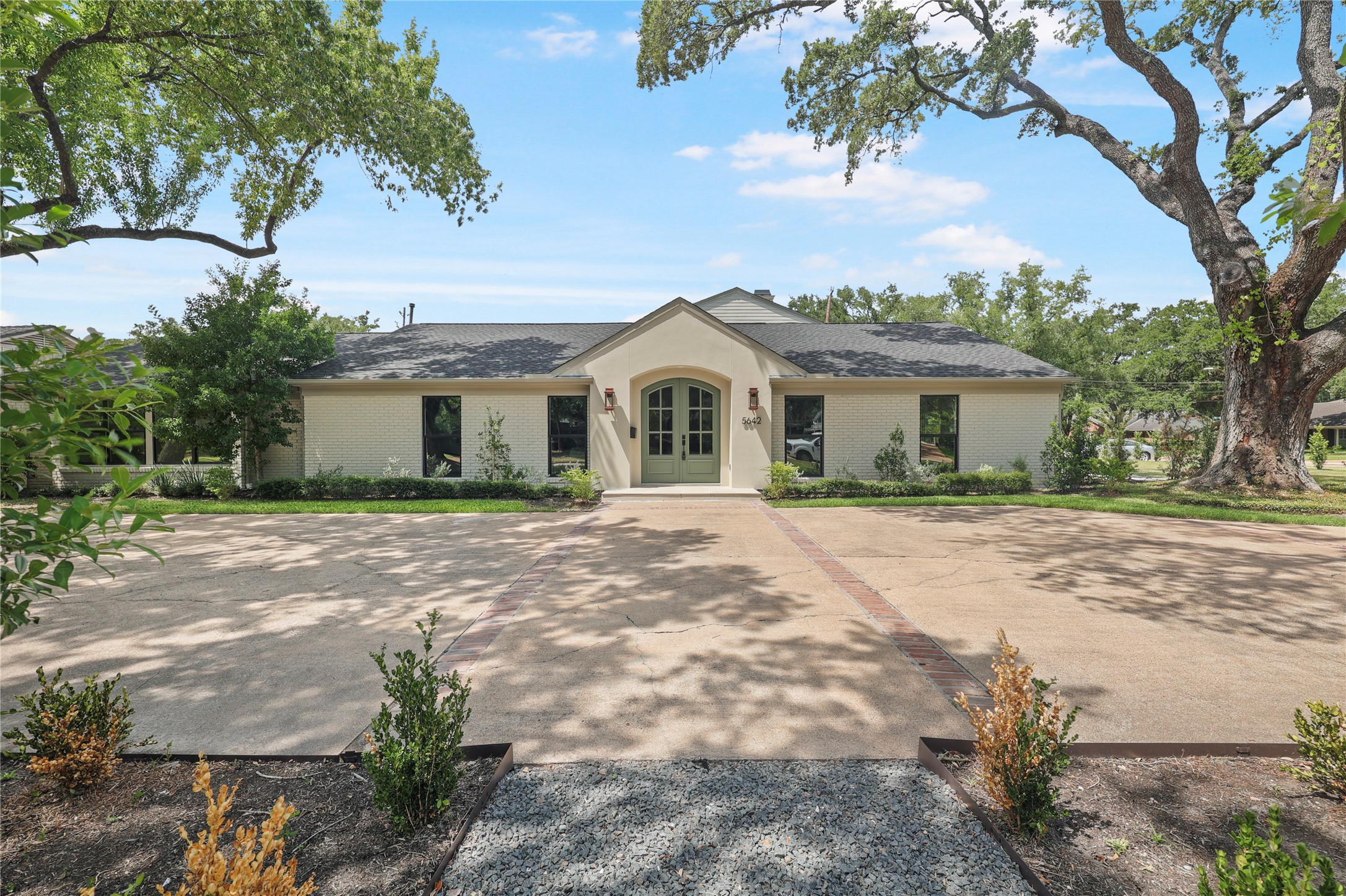 5642 Pine Forest Road Houston, TX 77056 - Photo 2 of 32 Oversized lots like this are becoming increasingly rare in Tanglewood. Framed by majestic trees and generous setbacks, the arrival feels private, established, and effortlessly timeless.