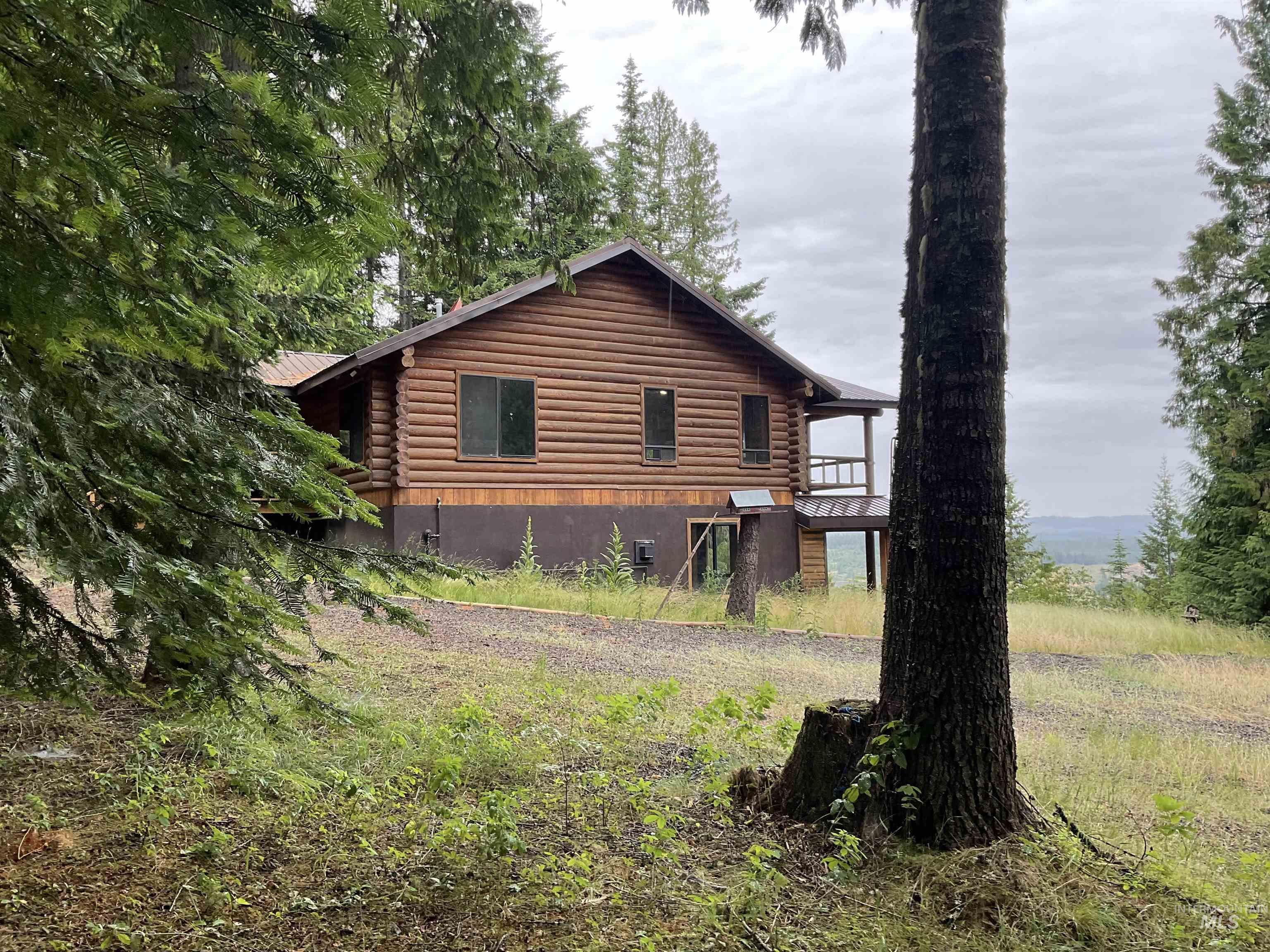 6125 Freeman Creek Road Lenore, ID 83541 - Photo 5 of 44 Wood-sided residence with log-style construction and a covered deck