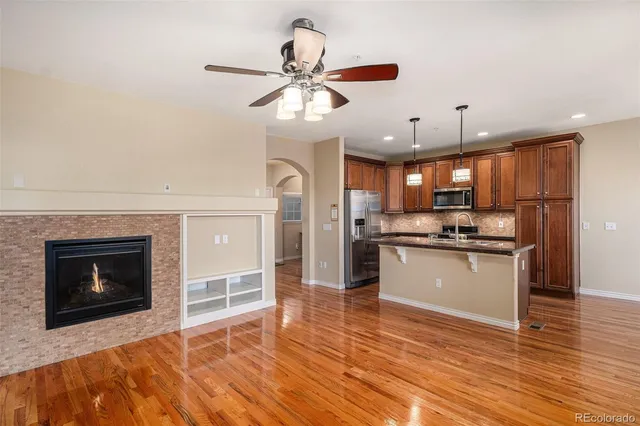 a kitchen with granite countertop a stove a refrigerator and a fireplace