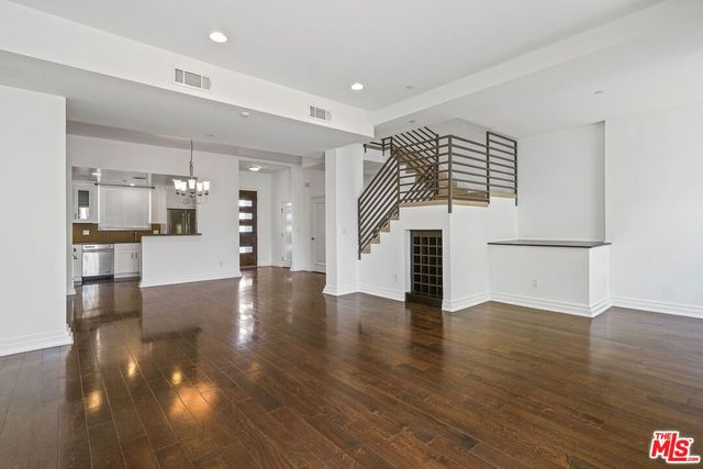 a view of a kitchen with furniture and wooden floor