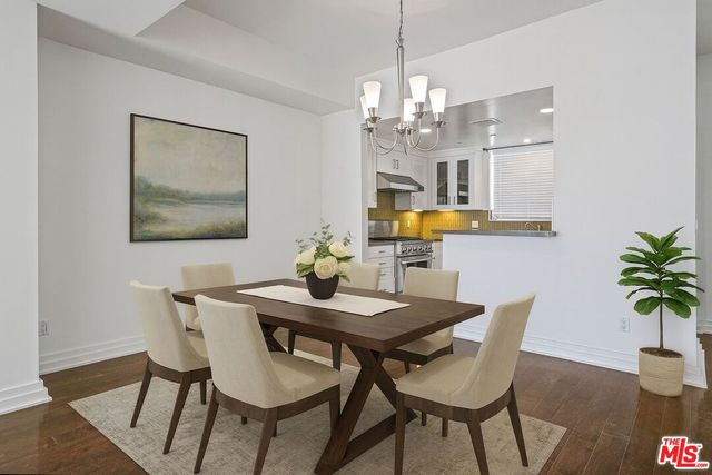 a view of a dining room with furniture and chandelier