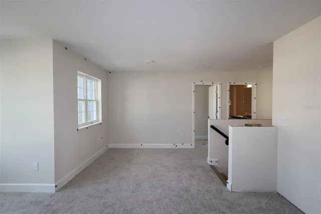 an empty room with a stove and mirror