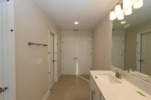 a bathroom with a sink vanity and a mirror