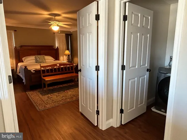 a view of bedroom with a bed and wooden floor