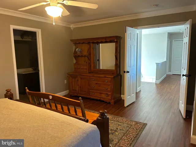 a bedroom with furniture and wooden floor