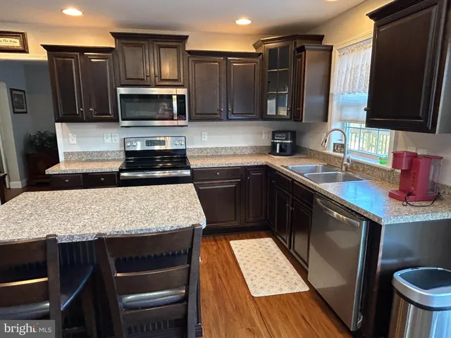 a kitchen with a sink stove and microwave