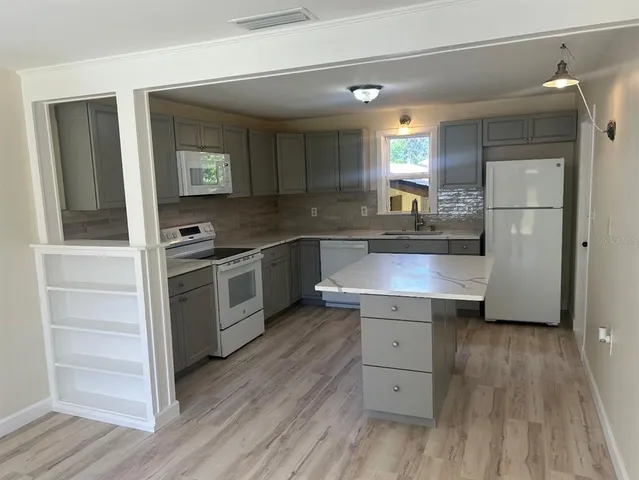 a kitchen with a sink and refrigerator