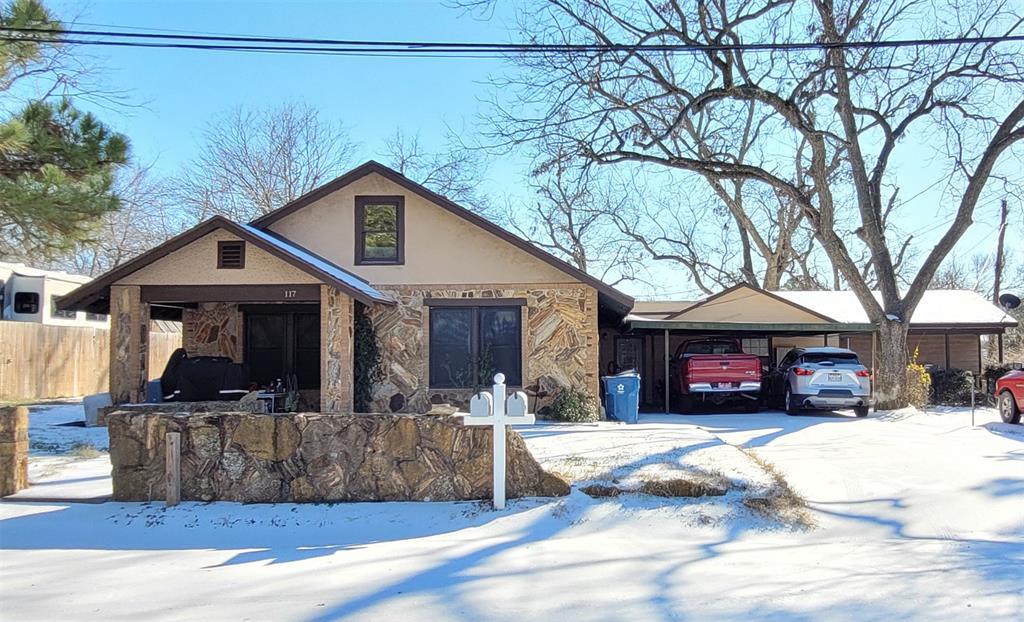 117 West 3rd Street, Unit A Keene, TX 76059 - Photo 2 of 14 a view of a house with a yard covered in snow