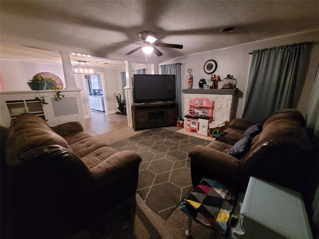 117 West 3rd Street, Unit A Keene, TX 76059 - Photo 3 of 14 a living room with furniture and a flat screen tv