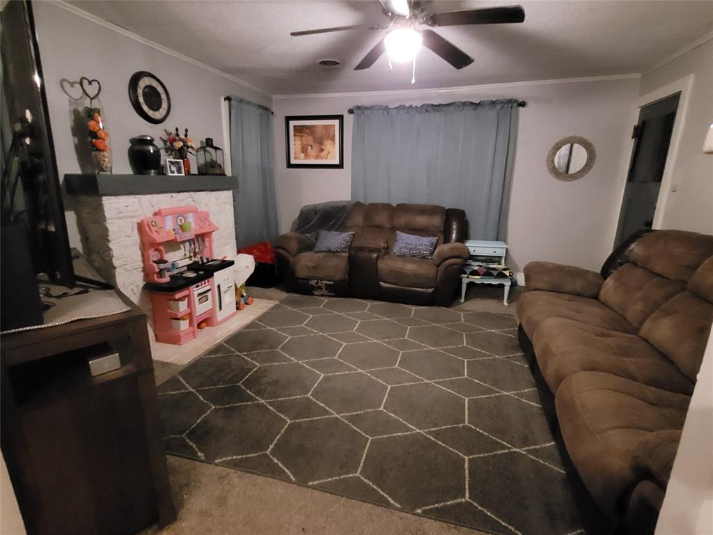 117 West 3rd Street, Unit A Keene, TX 76059 - Photo 4 of 14 a living room with furniture a couch and a flat screen tv