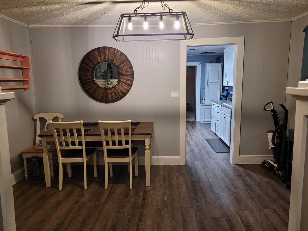 117 West 3rd Street, Unit A Keene, TX 76059 - Photo 6 of 14 a view of a dining room with furniture and wooden floor
