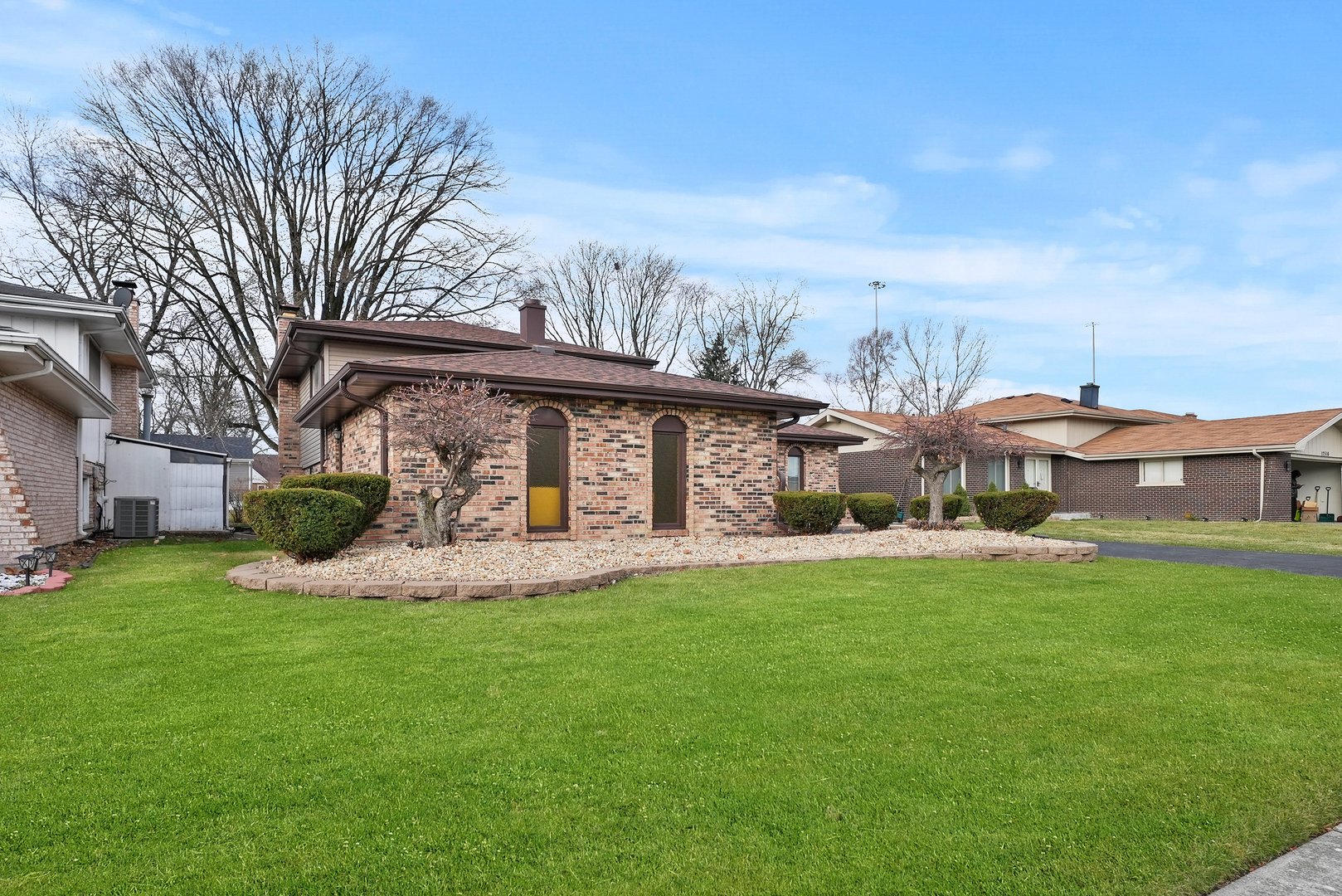 a front view of house with yard barbeque and outdoor seating